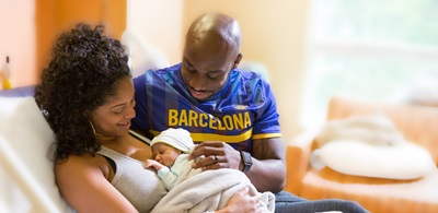 couple gazing at newborn