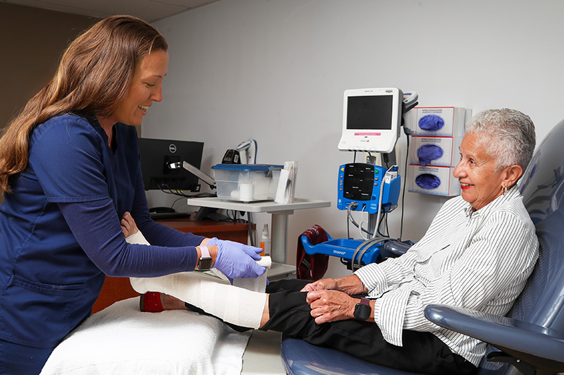 Nurse wraps a patients legs